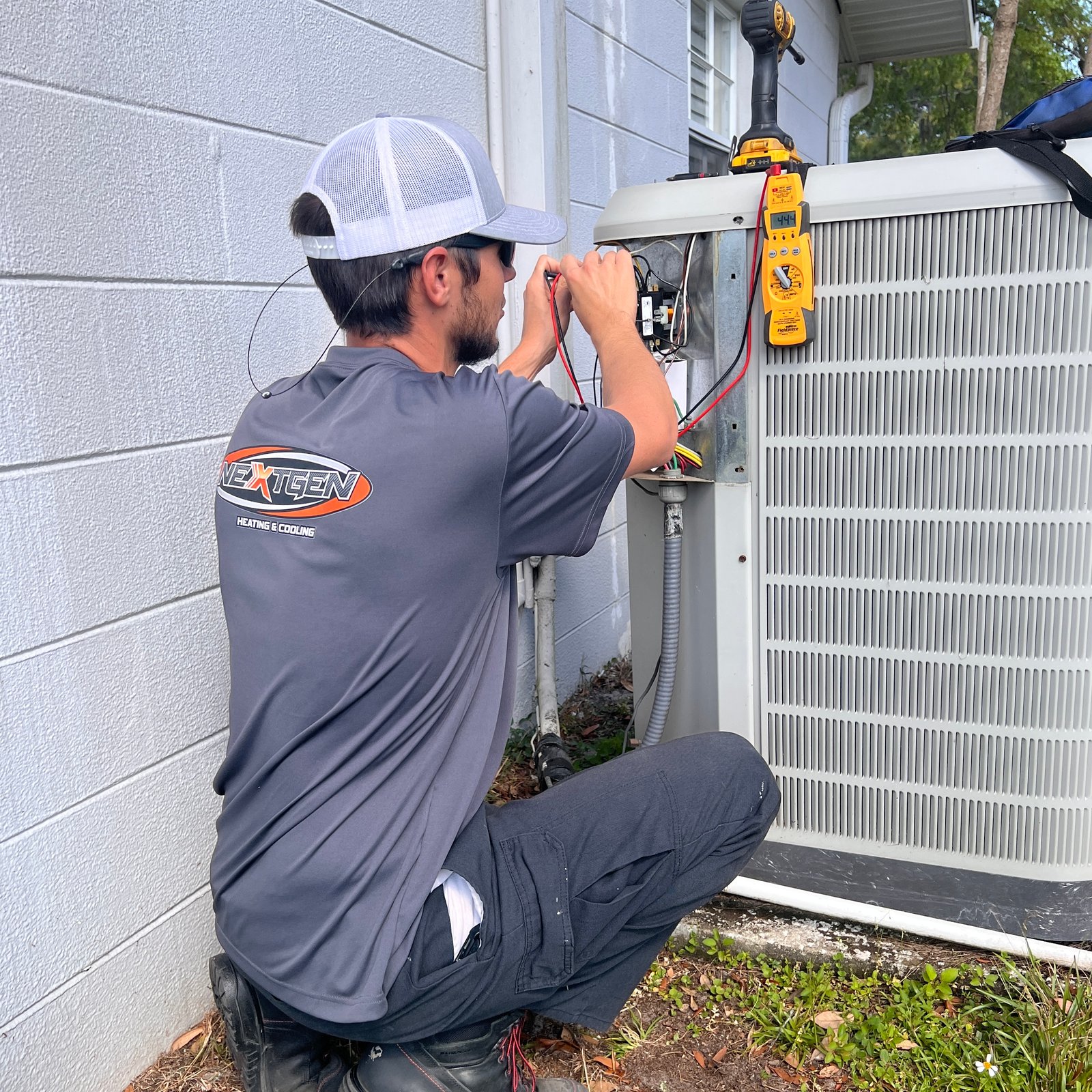 Multiple outdoor air conditioning units lined up on a rooftop, providing cooling for a commercial building